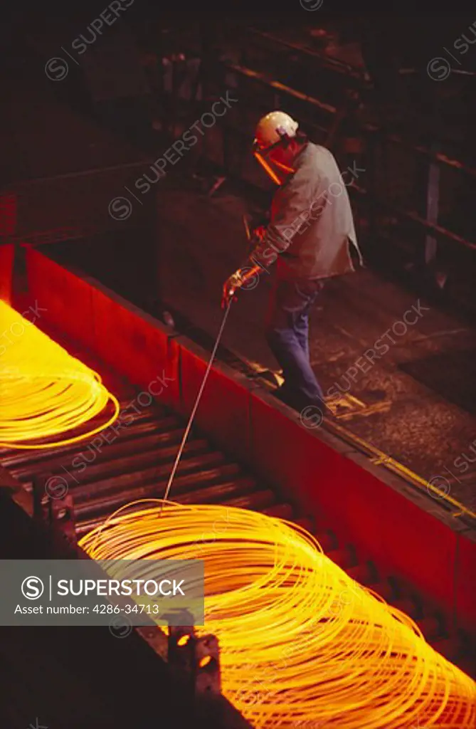 Steel rod being coiled for use as wire at Northwestern Steel in Illinois.  Other steelmaking shots available.
