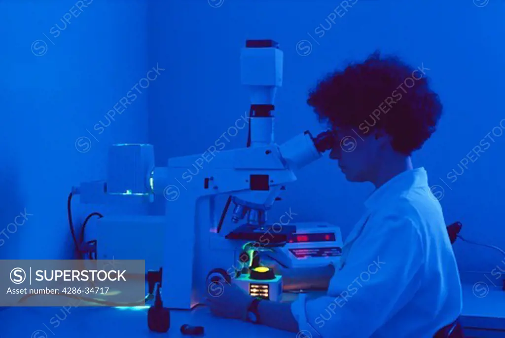 Woman scientist using a microscope in a biomedical laboratory in Maryland