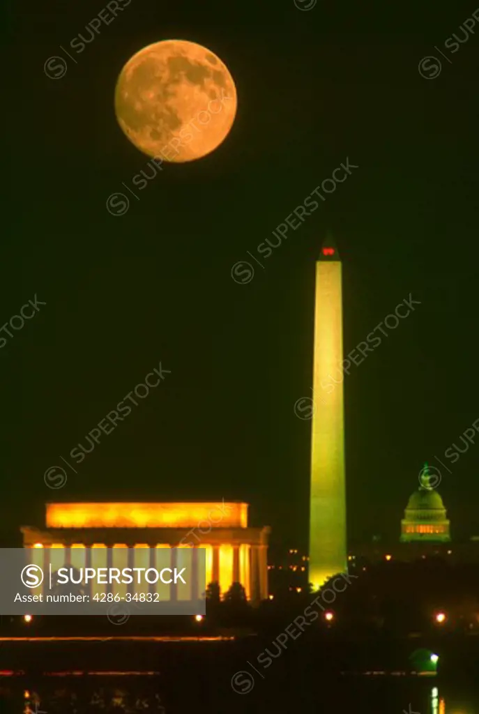 Moonrise over Washington, DC skyline showing Lincoln Memorial, Washington Monument and the Capitol.