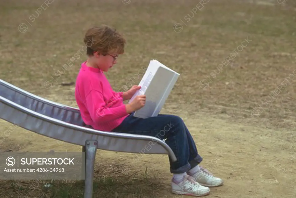 Female student studies alone during class recess.  (model released)