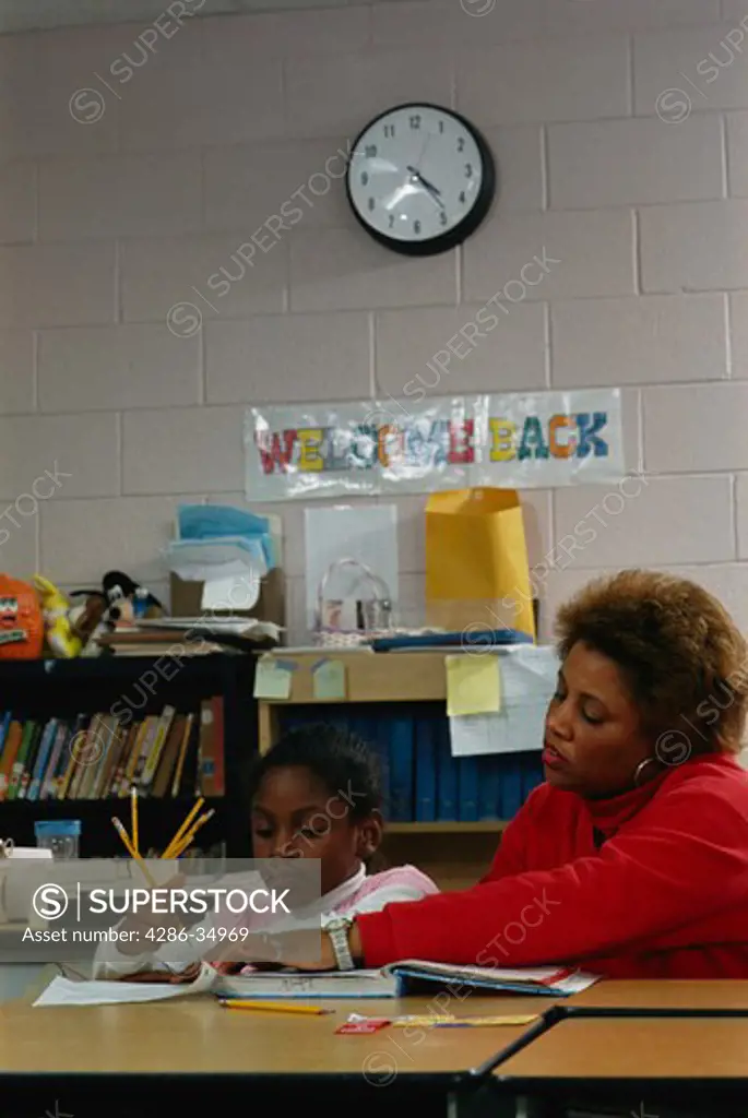 Student with teacher in after-school study hall.  (model released)