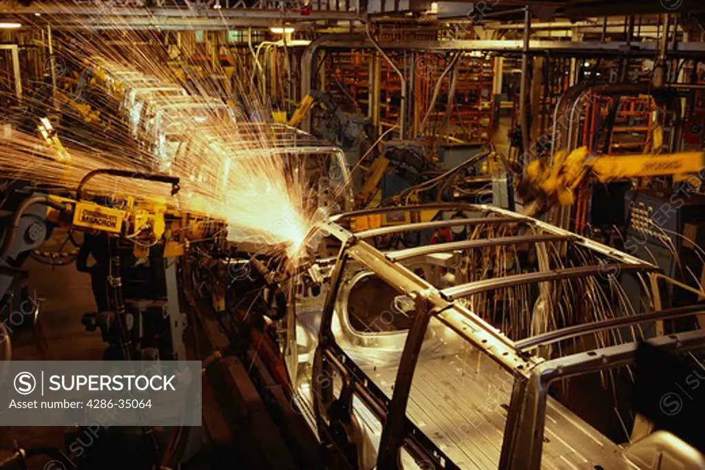 Robots weld van bodies at General Motors plant in Baltimore, MD. - DA 4037
