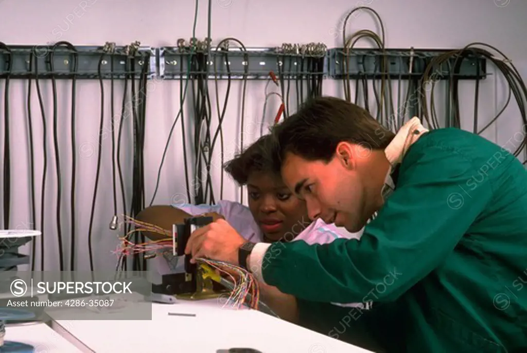 Technician work on wiring telephone equipment - BC12034