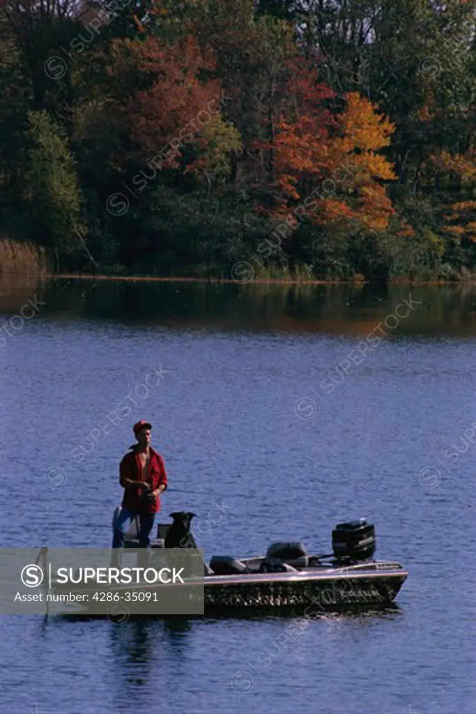 Man fishing on lake in Connecticut - DA37432