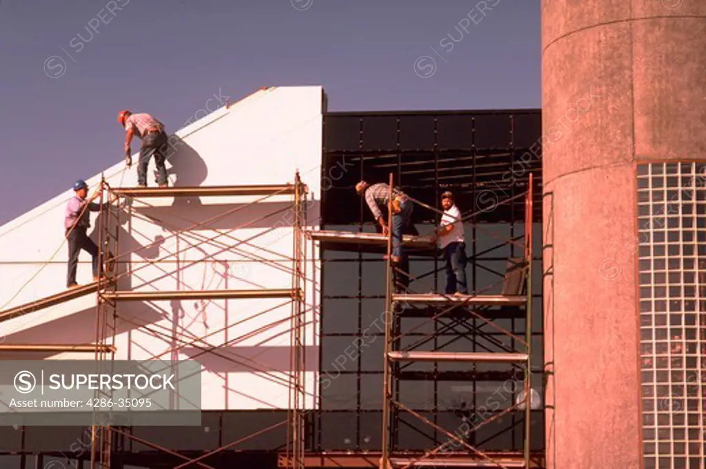 Construction workers install panels on office building in Virginia. - HL 1864
