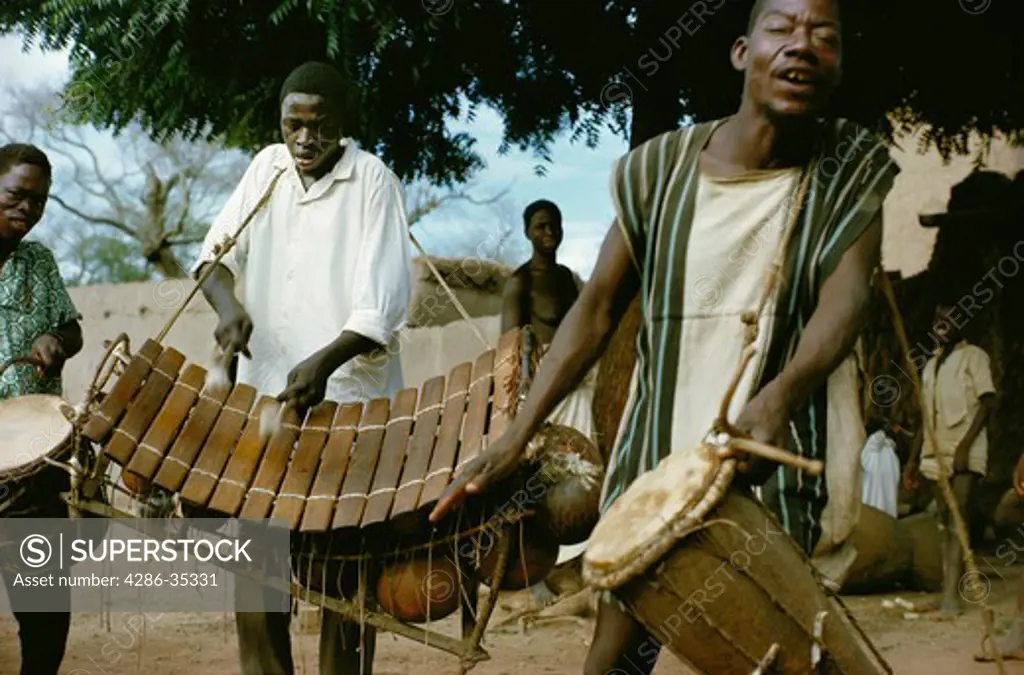 Musicians of Bobo tribe playing drums and balafon xylophone in Koumbia, Burkina Faso, Africa.