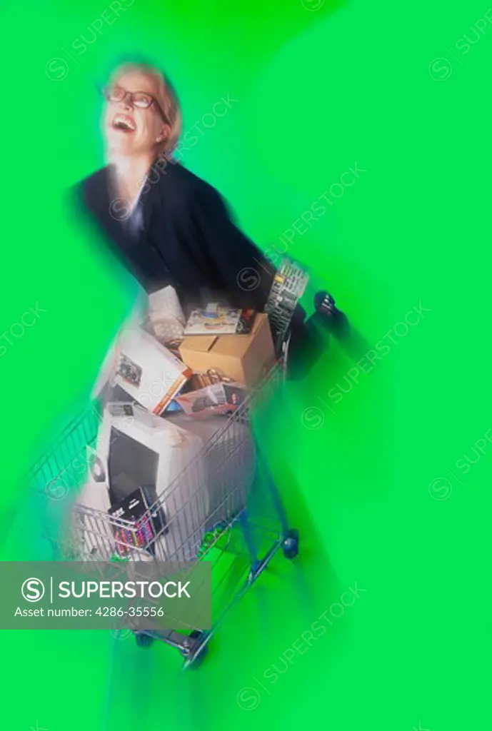 Blurred view of a woman pushing a shopping cart full of computer equipment and supplies.