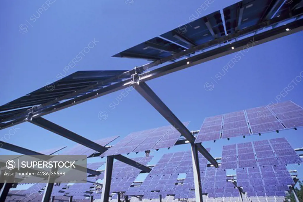 Close-up view from below of solar panels taken during the day. 