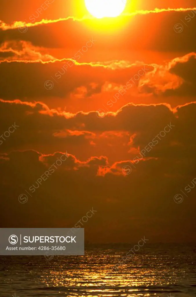 Spectacular sunrise over the ocean.  Dramatic sky with layers of clouds.  Colorful shot taken on the Atlantic coastline in Delaware.  (Nature.  Sunrise/Sunsets.   Concepts.  Backgrounds.)