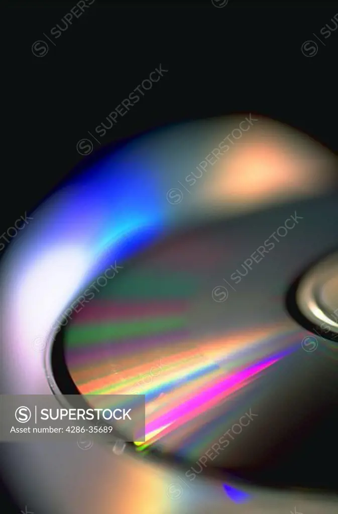 CD ROM discs.  Compact discs.  Close-up showing brilliant colors and strong graphic design.  (Computers.  High Tech.  Abstracts.  Backgrounds.)