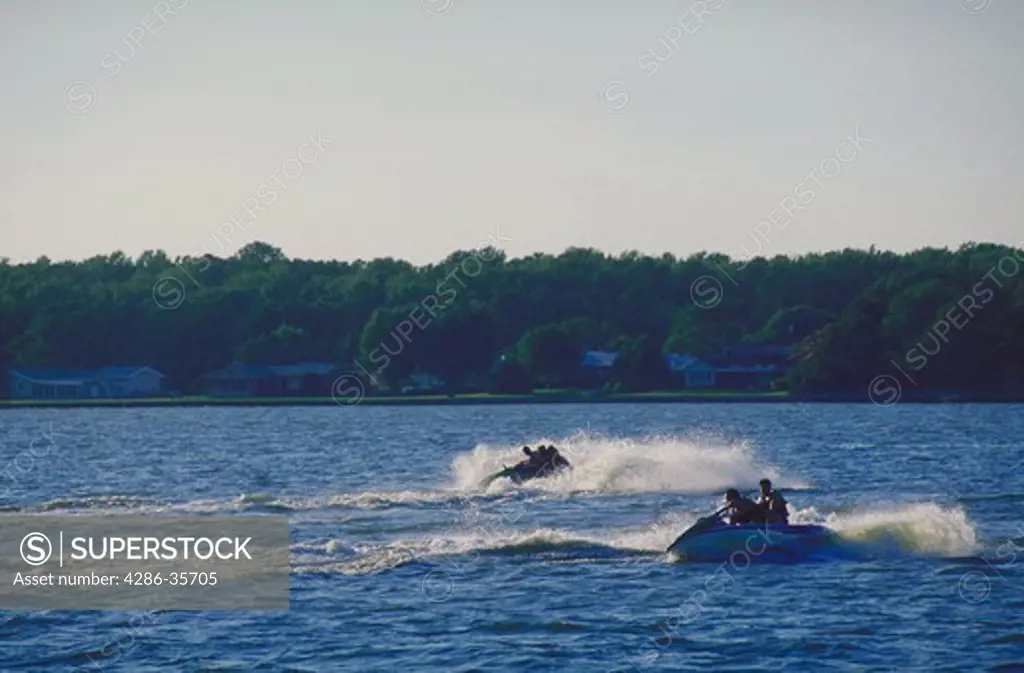 Two personal watercraft (PWC) (also known as jet skis or waverunners) on Rehoboth Bay, Delaware.  John Hartman has an extensive file of boating and water related imagery.
