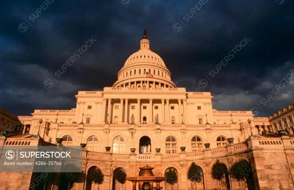 U.S. Capitol Building, west side, in dramatic light as a storm is clearing. Washington, D.C.  Other variations and large D.C. file available. (Travel. Politics. Concept. Architecture.) 