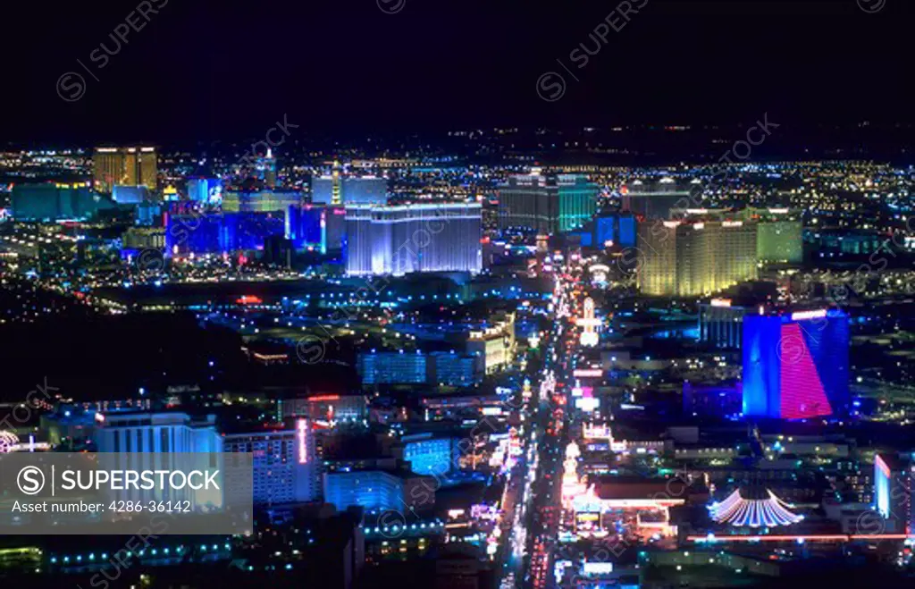 Aerial view of the Las Vegas strip with lights of hotels and casinos at night.