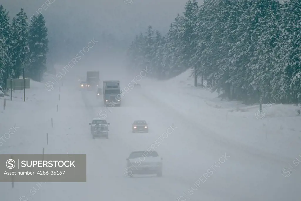 Traffic in a snow covered road on Highway 97 in Central Oregon. 