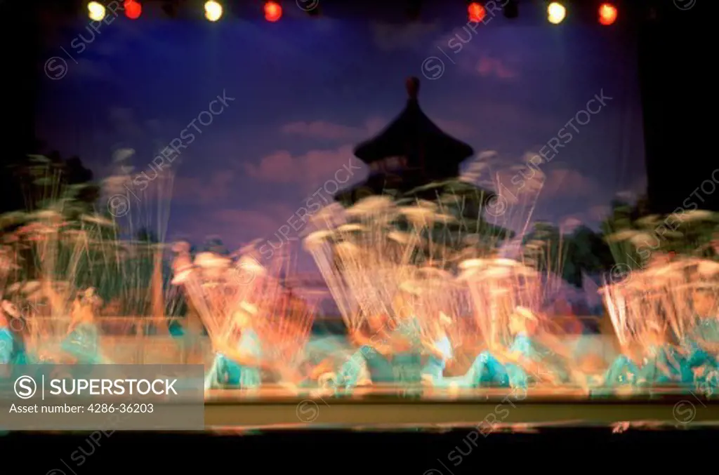 Blurry view of Chinese acrobats in Chaoyang Theater in Beijing, China. 