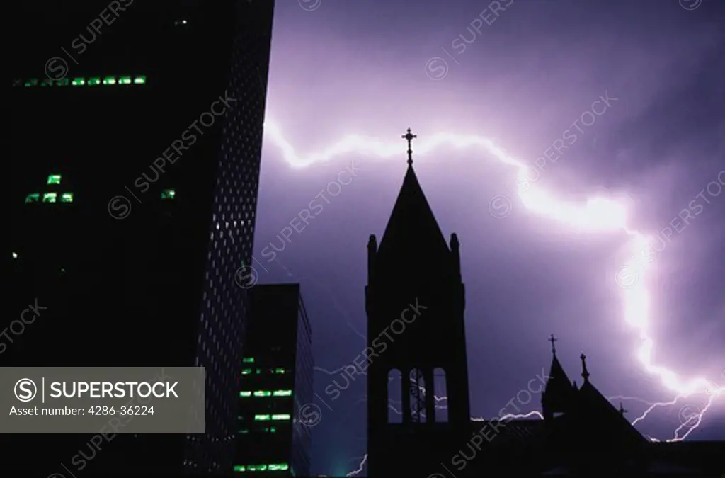 Lightning streaks across the dark night sky behind Central Presbyterian church and downtown buildings, Denver, Colorado.  Property release available for church.