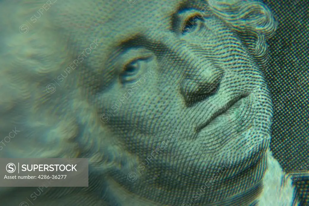 Close-up, still life of George Washingtons face on a One Dollar bill.