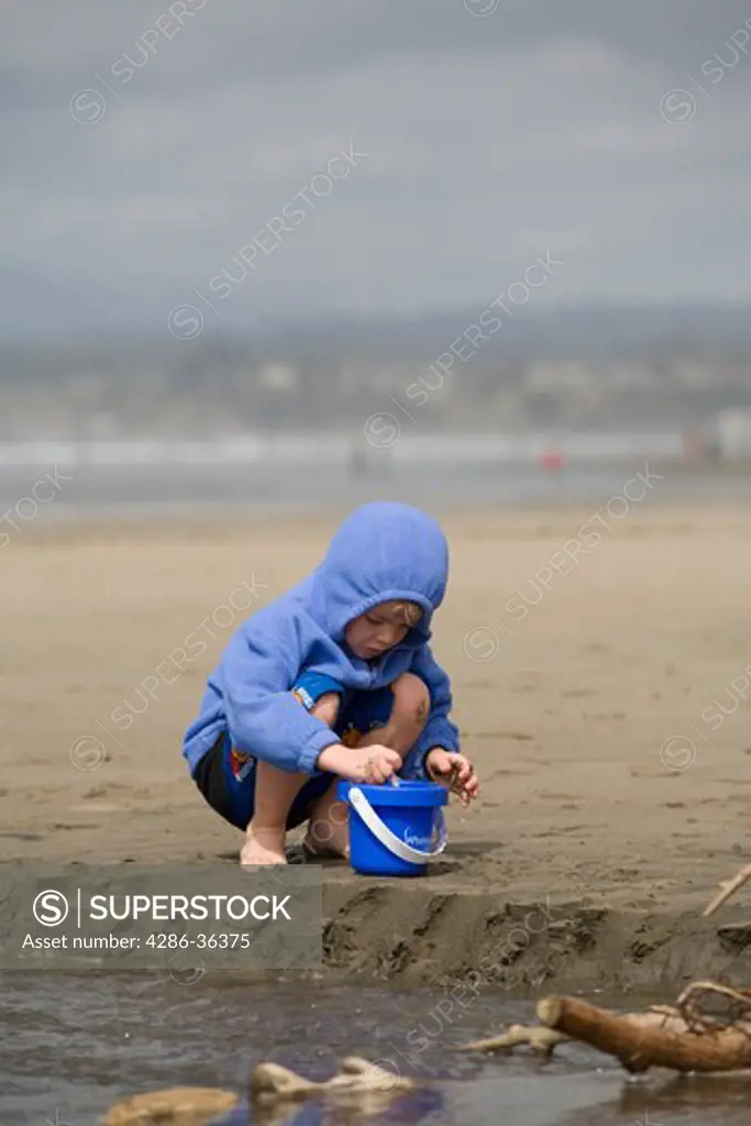 Boy Digging in the Sand on the beach