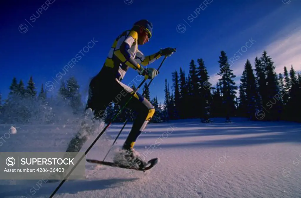 Man snowshoe running