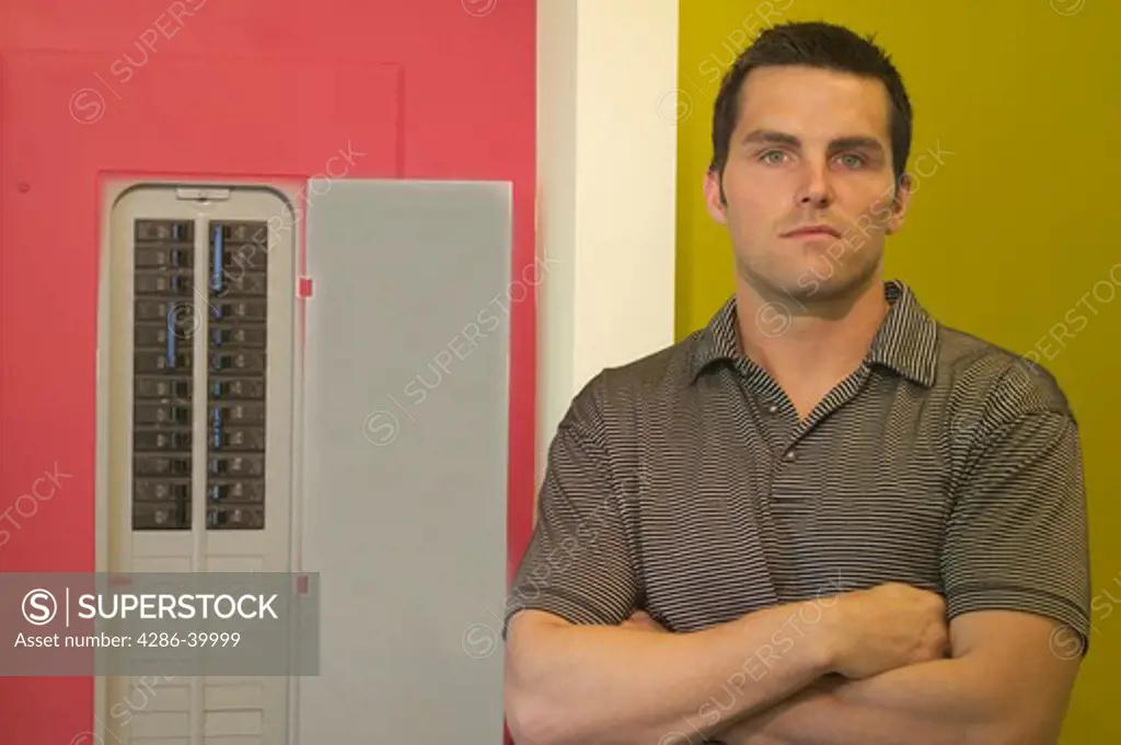Man posing beside electrical panel  MR-0406 PR-0407