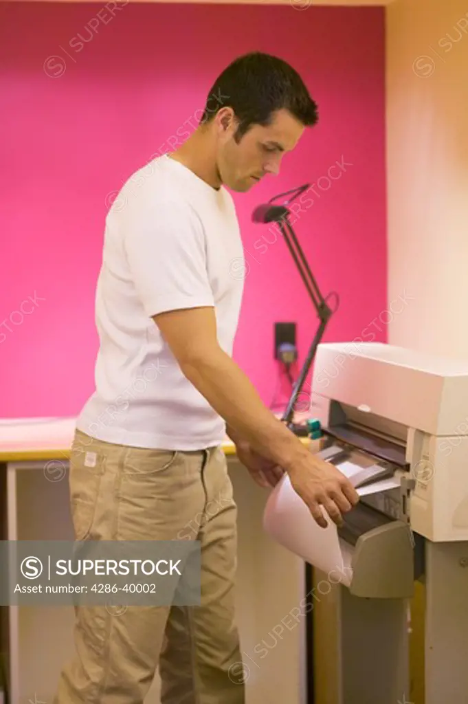 Man attending to printer plotter  MR-0406 PR-0407