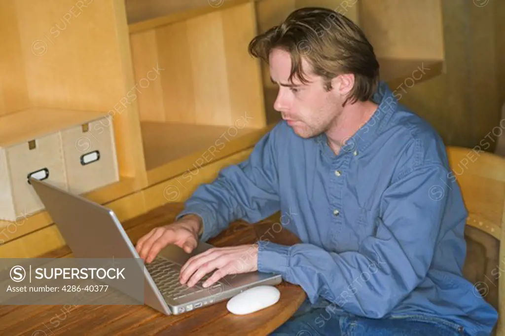 Man working on laptop.  MR-0429 PR-0419