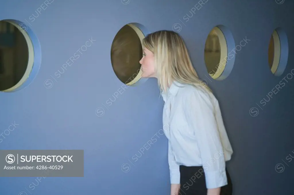 Business woman looking through port holes.  MR-0538 PR-0527