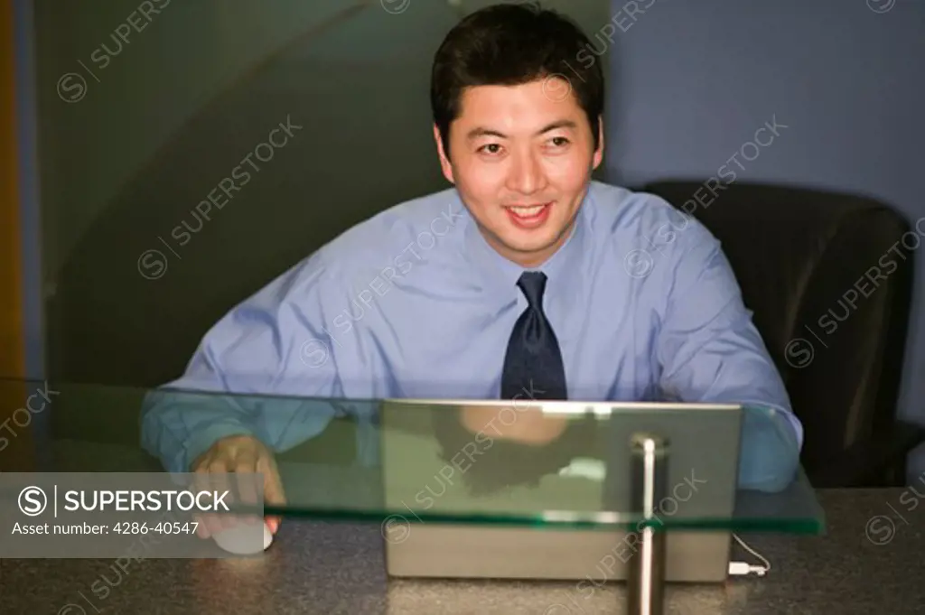 Asian male at reception desk.  MR-0525 PR-0527