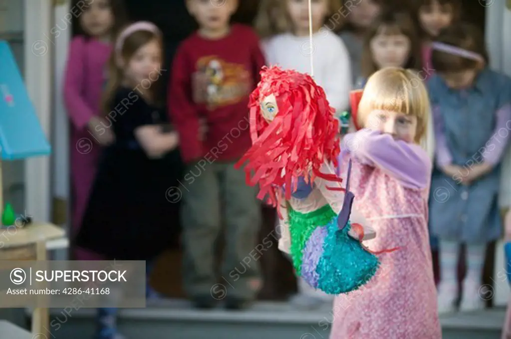 Children Trying to Break Open a Pinata at a Birthday Party