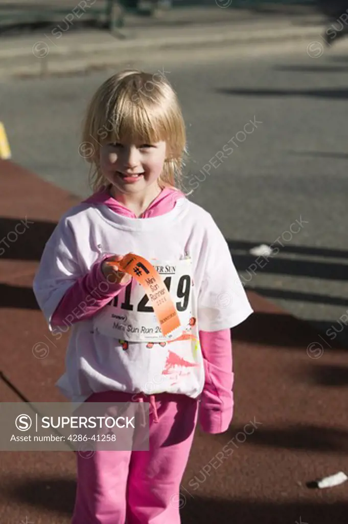 Vancouver Sun Fun Run Kids and Parents 2.5km Event. Young Participant Holding Ribbon, MR-0601