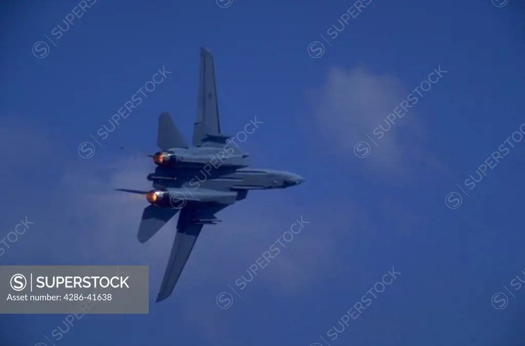 F-15 military airplane in flight against blue sky, Frederick, Maryland.