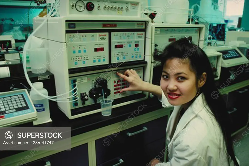 female bio-engineer at equipment, CA