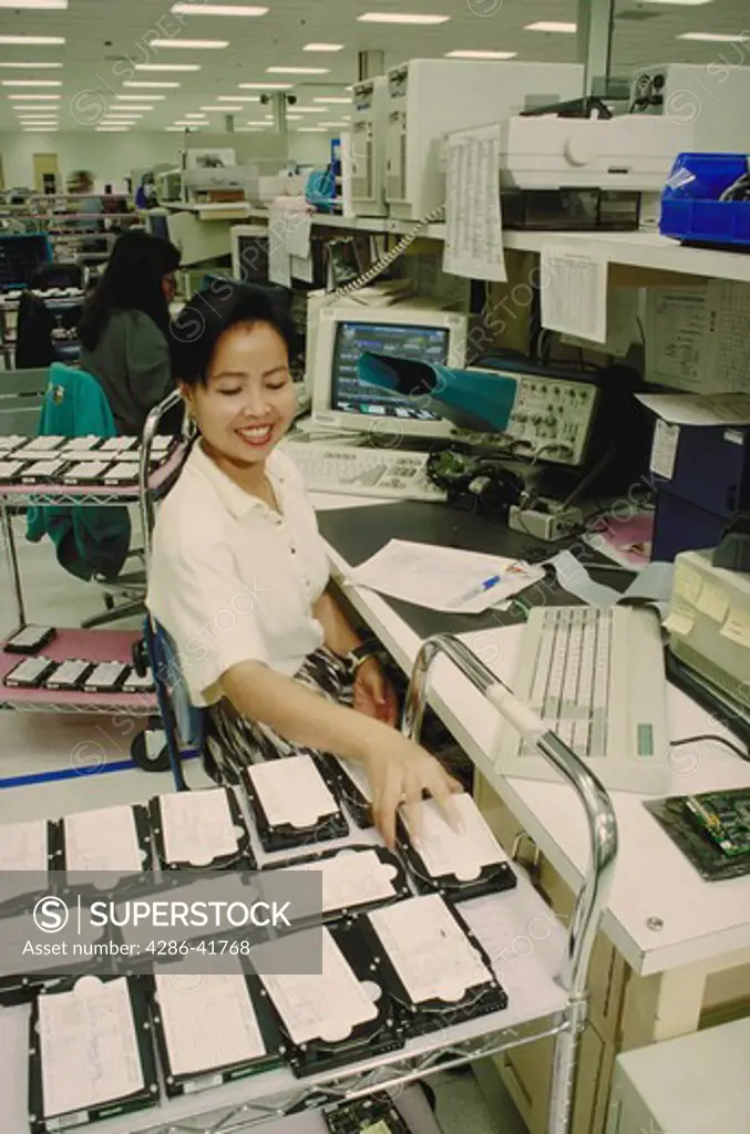 Cambodian female testing computer hard disk drives, CA