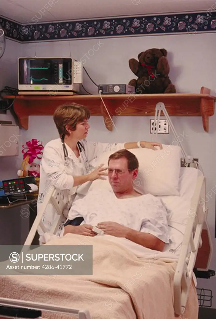 nurse and patient in hospital intensive care, CA
