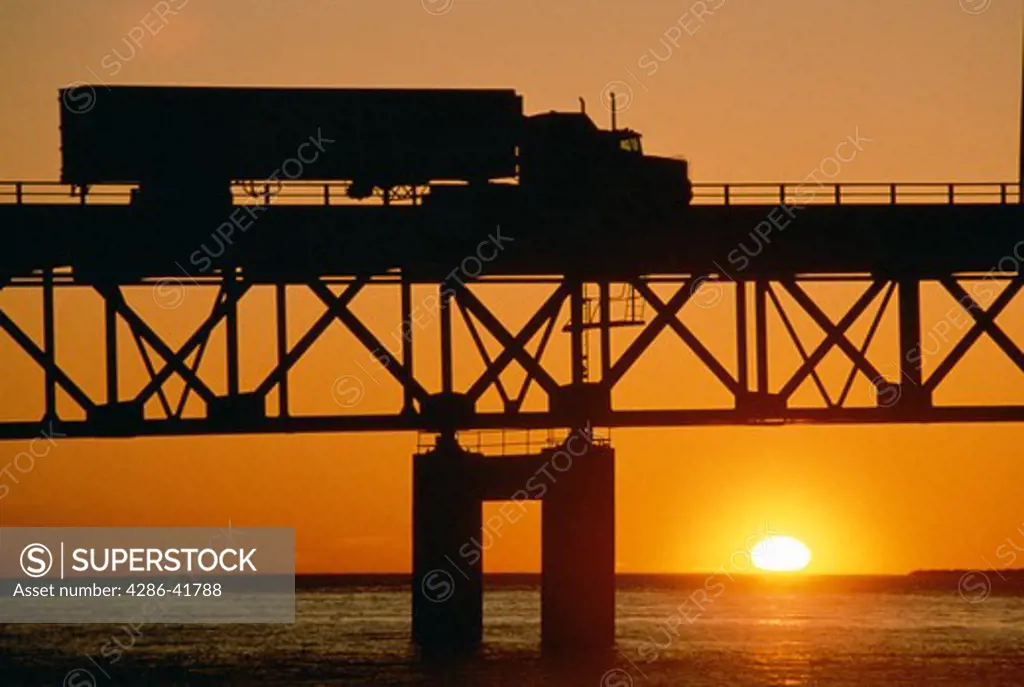 Truck on bridge and sunset