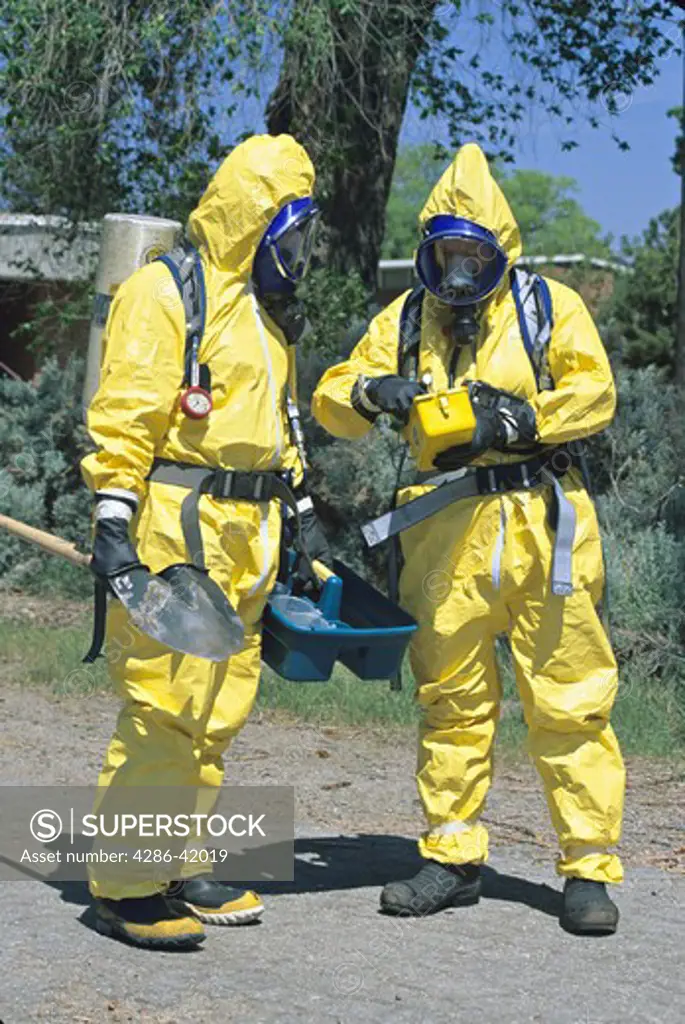 hazmat team prepares to approach toxic substance spill