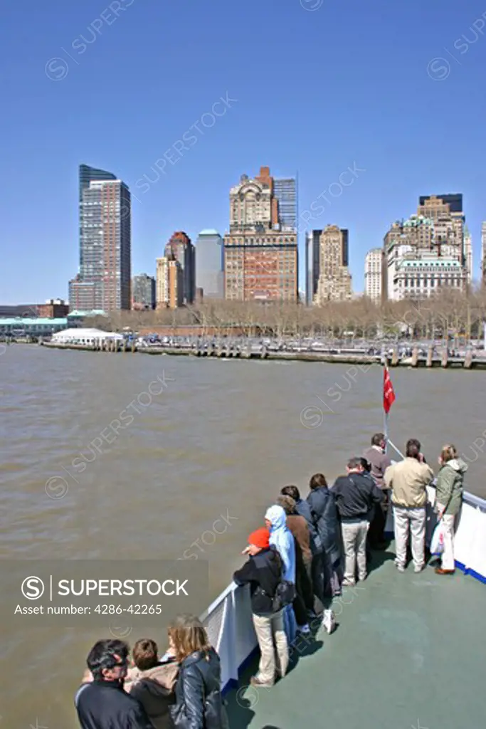 People on ferry boat arriving at Battery Park New York City