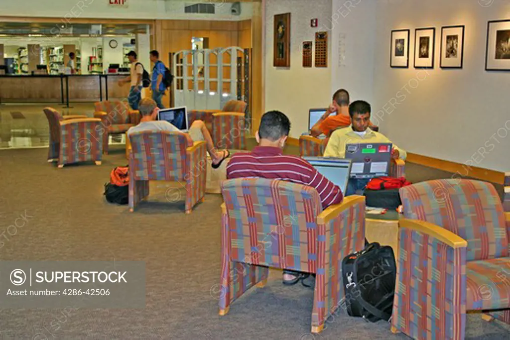 Ethnic male students studying using laptop computers in new library Oregon State University in Corvallis Oregon