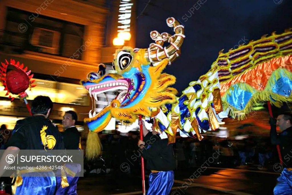 Men dancing with dragon in Chinese New Year parade San Francisco California