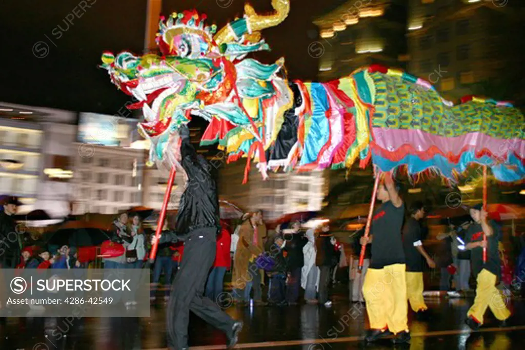 Men dancing with dragon in Chinese New Year parade San Francisco California