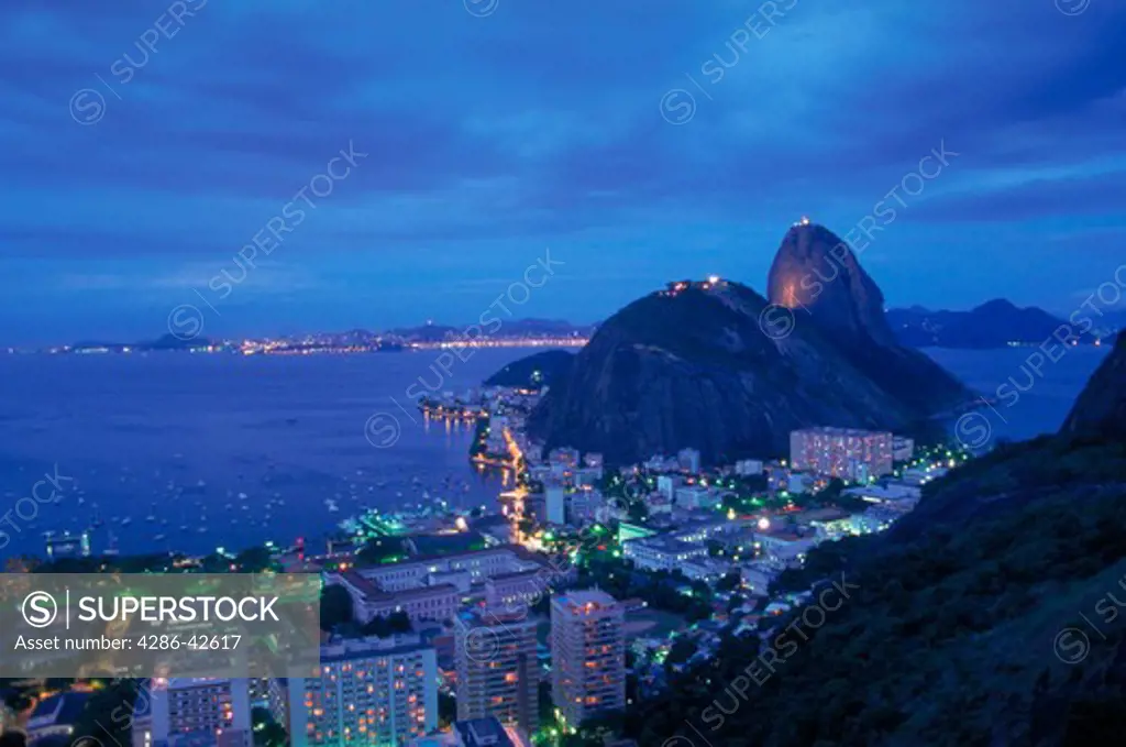 Aerial view of the lights of Rio de Janeiro, Brazil and Sugarloaf at dusk.