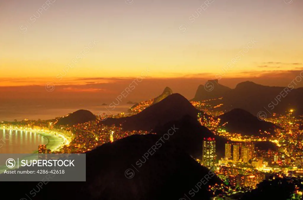 Aerial view at sunset of Rio de Janeiro, Brazil from atop Sugarloaf with the world famous Copacabana Beach to the left.