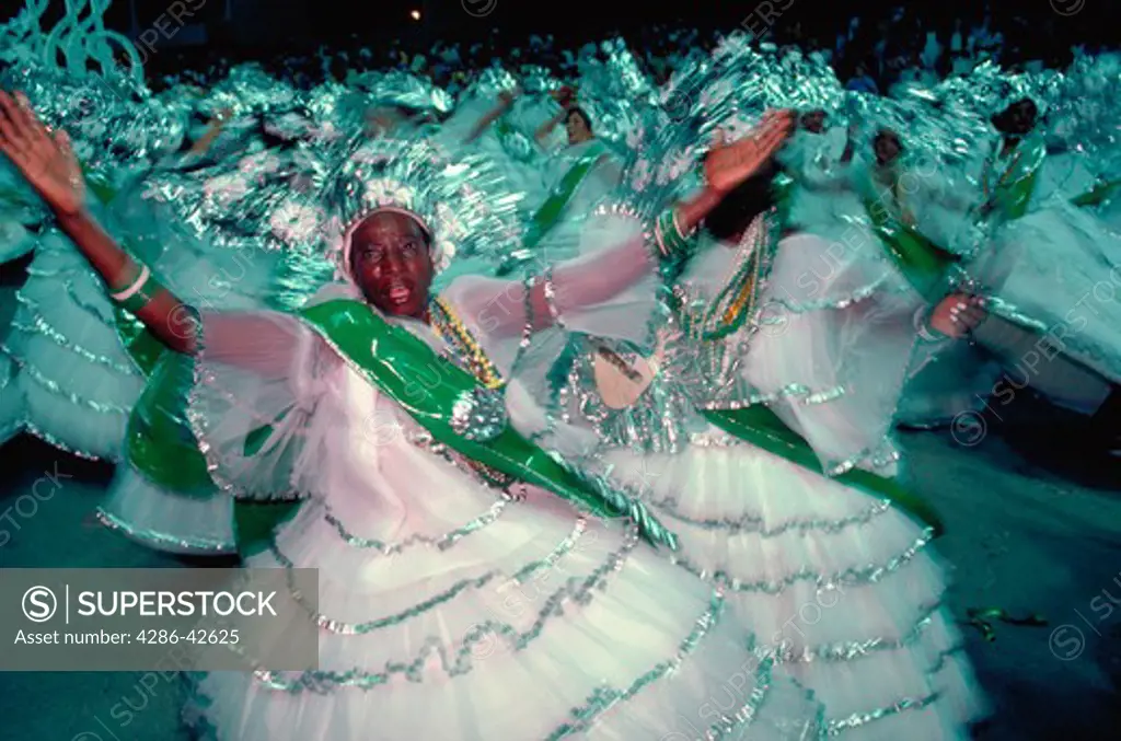 Baianas in elaborate costumes dance at the parade of the Samba School at the Sambadrome during Carnaval in Rio de Janeiro, Brazil.