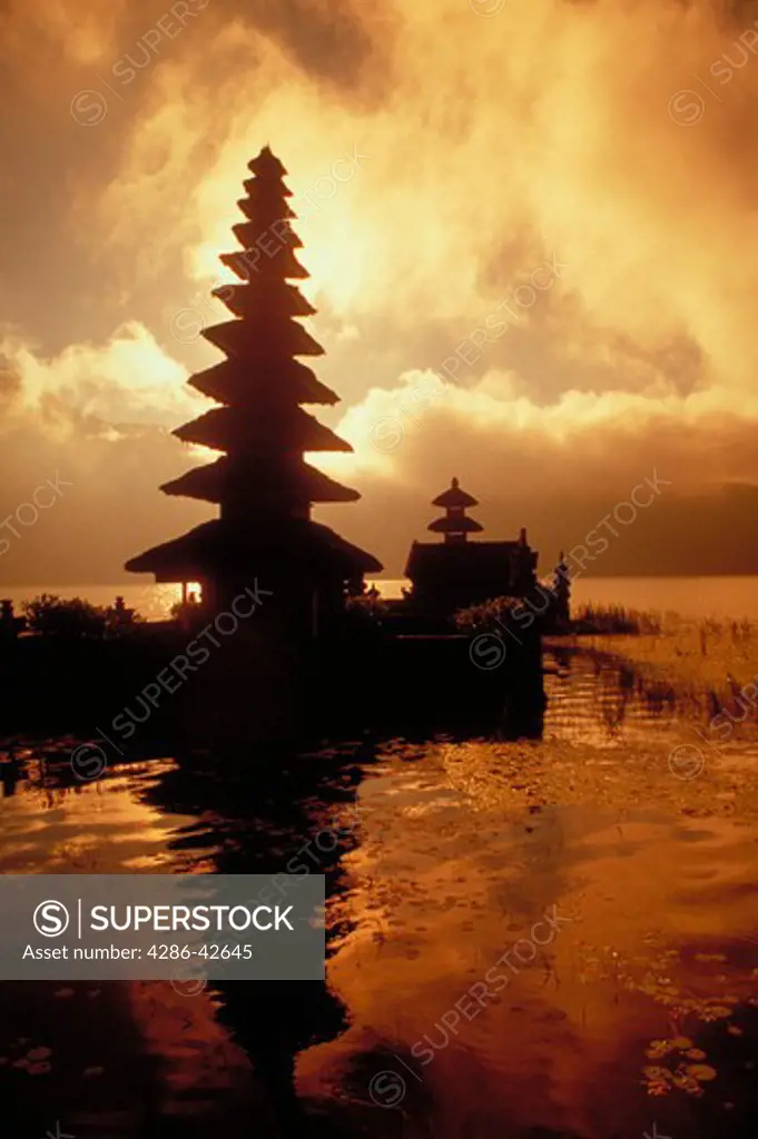 Ulun Danu Temple on Lake Bratan, Bali, Indonesia silhouetted against the sky.