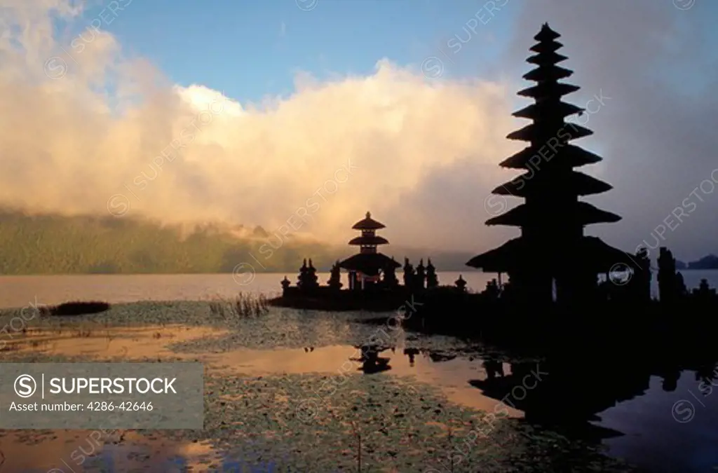 Ulun Danu Temple on Lake Bratan, Bali, Indonesia silhouetted against the sky.