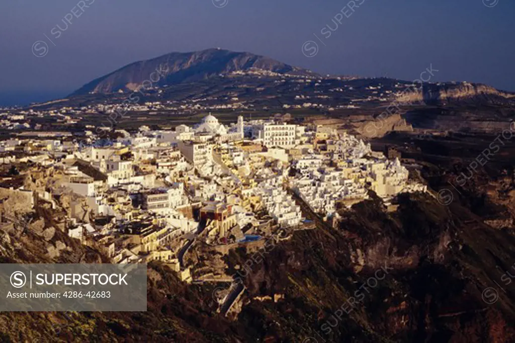 The whitewashed buildings of the village of Fira on the ridge of a hill on the island of Santorini, Greece.
