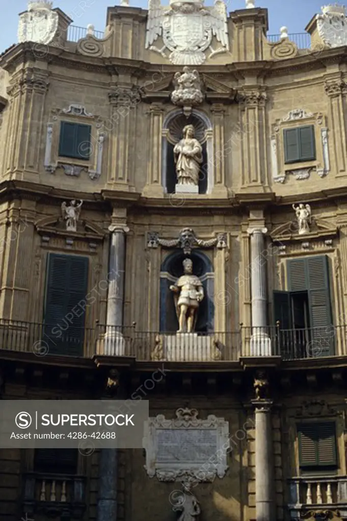 Exterior of a Baroque style building decorated with statues at the Quattro Canti, the traditional center of Palermo, Italy