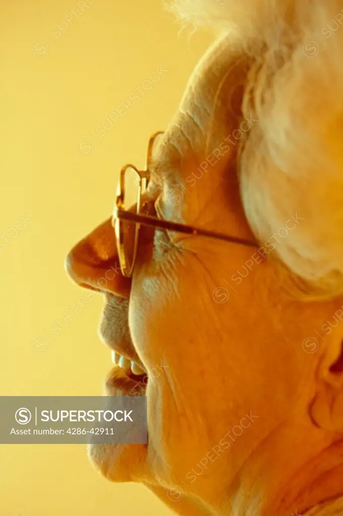 Close-up profile portrait of a smiling senior woman.