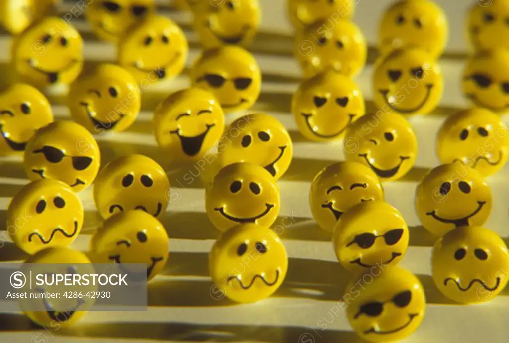 Still life of a group of yellow happy faces with various expressions.