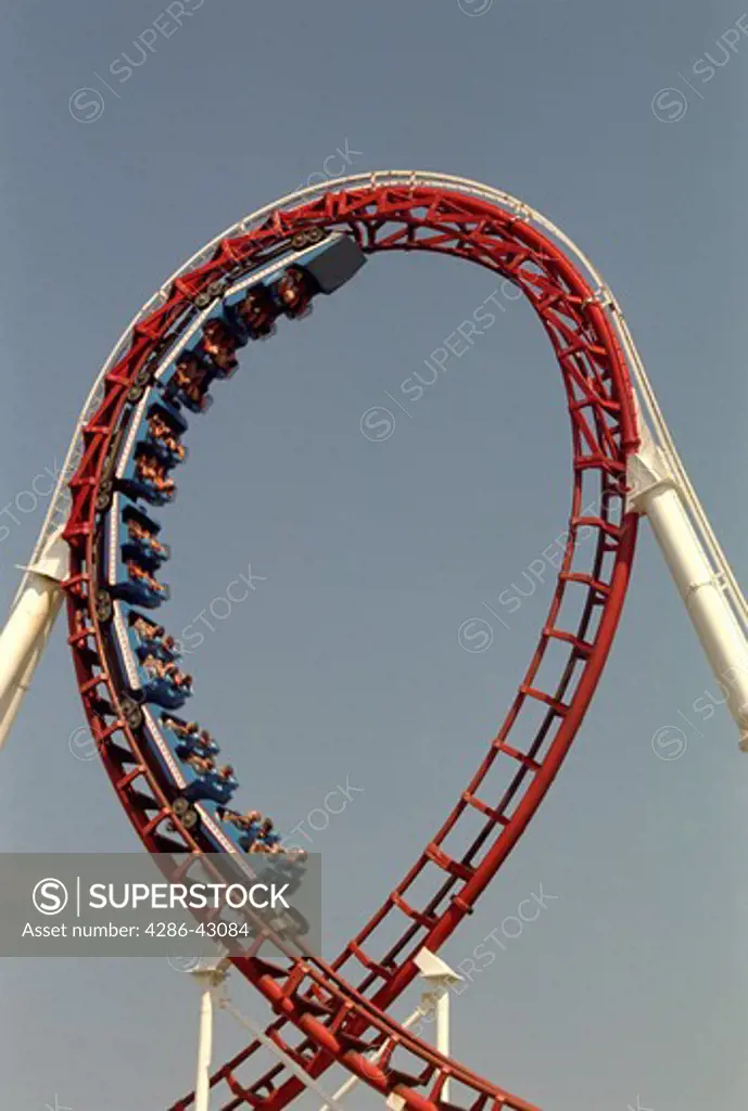A roller coaster is halfway through a loop.